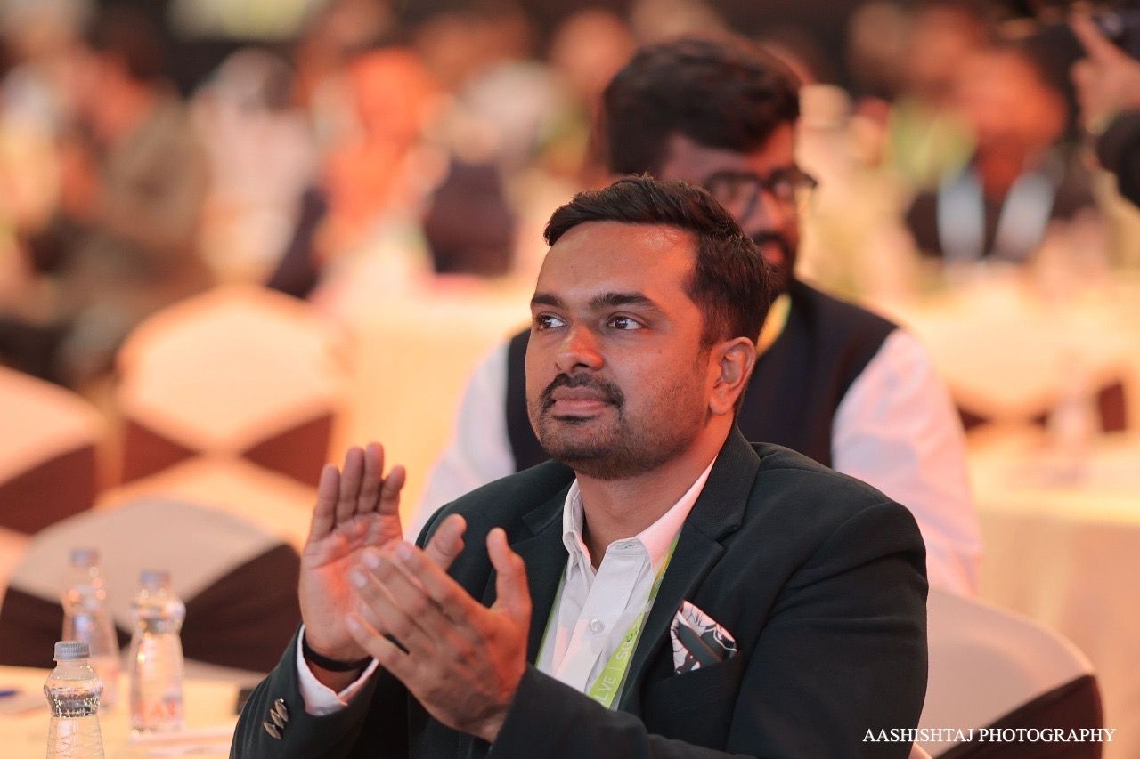 Parv Parmar applauding at an industry conclave