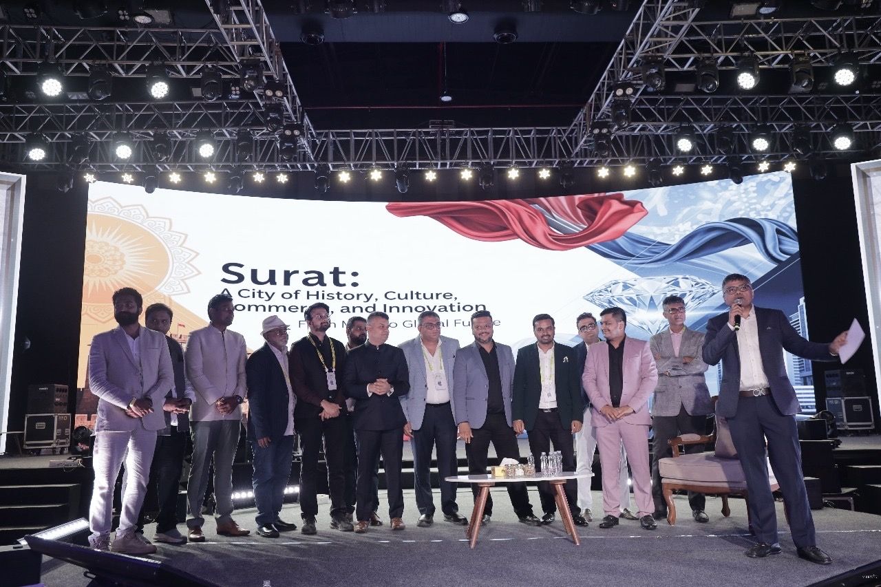 Industry leaders on stage before a Surat city presentation
